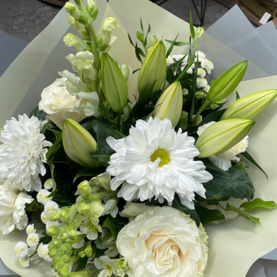 Classic Harmony - Share your sentiments with this beautiful arrangement of white and green blooms complemented by lush greenery. Presented in elegant wrapping.