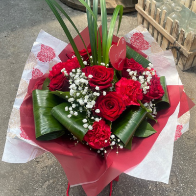 Smooch - 6 red roses and 6 red carnations with choice filler and foliage in a hand-tied or arrangement  in Oasis and presented in a gift bag or box.