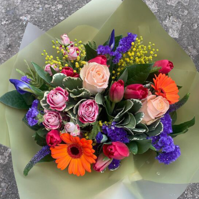 Hidden Treasure - An outstanding hand tied bouquet with a cascade of colour and a treasure chest overflowing with the beautiful flowers.