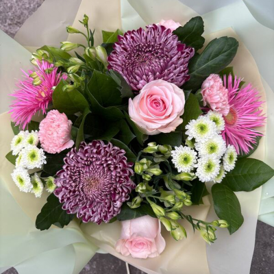 Petal Paradise - A lively bouquet featuring a bright mix of vibrant seasonal blooms. Complemented by lush green foliage and presented in a beautiful packaging, this arrangement is perfect for adding a pop of colour to any occasion