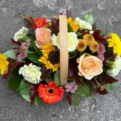 Autumn Hedgerow Basket - A collection of seasonal flowers and foliage arranged in a natural basket.