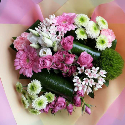 Blushing Meadow - A stunning collection of pink and green seasonal flowers in toning packaging. This bouquet is designed to impress and uplift any space.